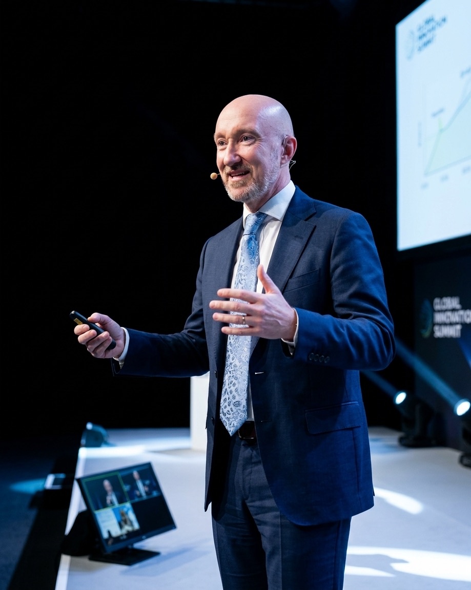 Phil Lupton speaking on stage at a conference